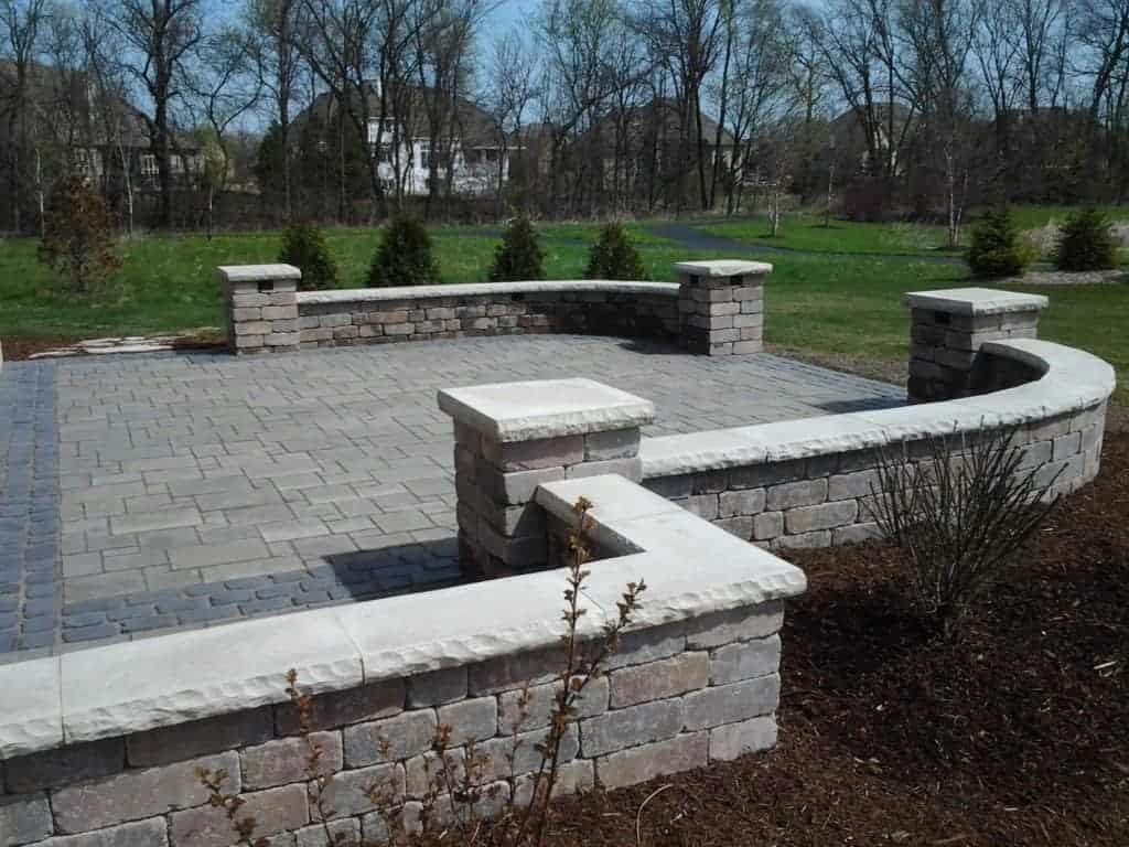 Avante ashlar patio with a Court stone .Olde quarry stone seat walls and pillars wity Ledge stone caps